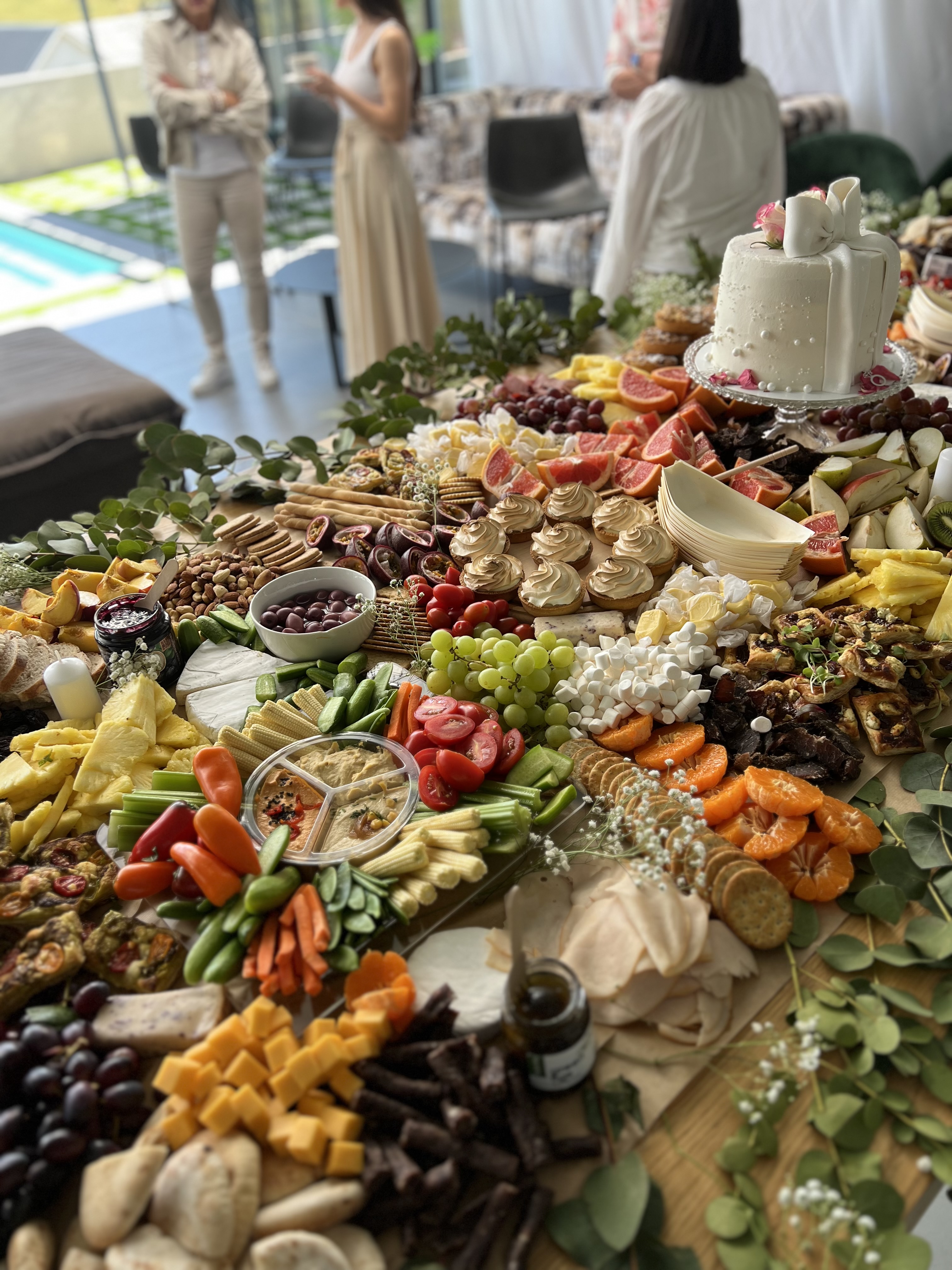 A grazing table beside a pool